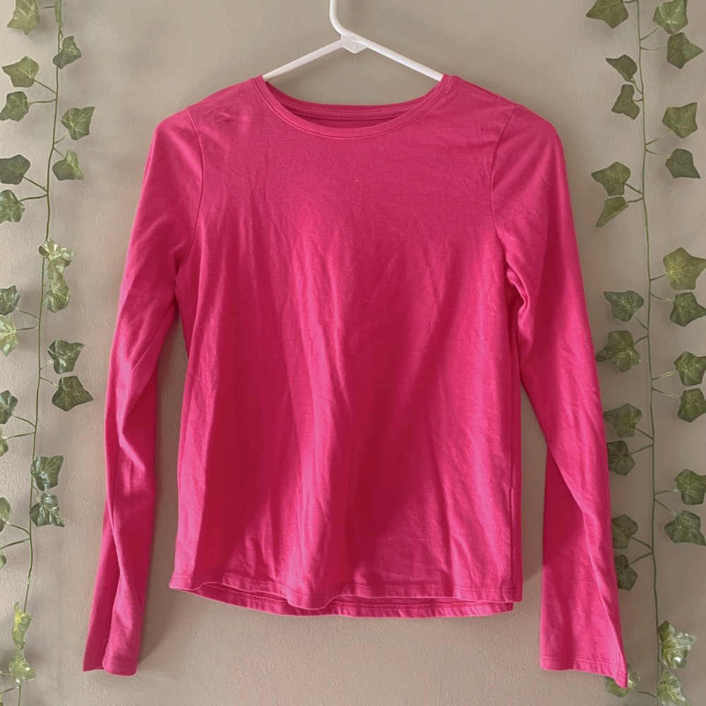 This is a bright pink long sleeve shirt.